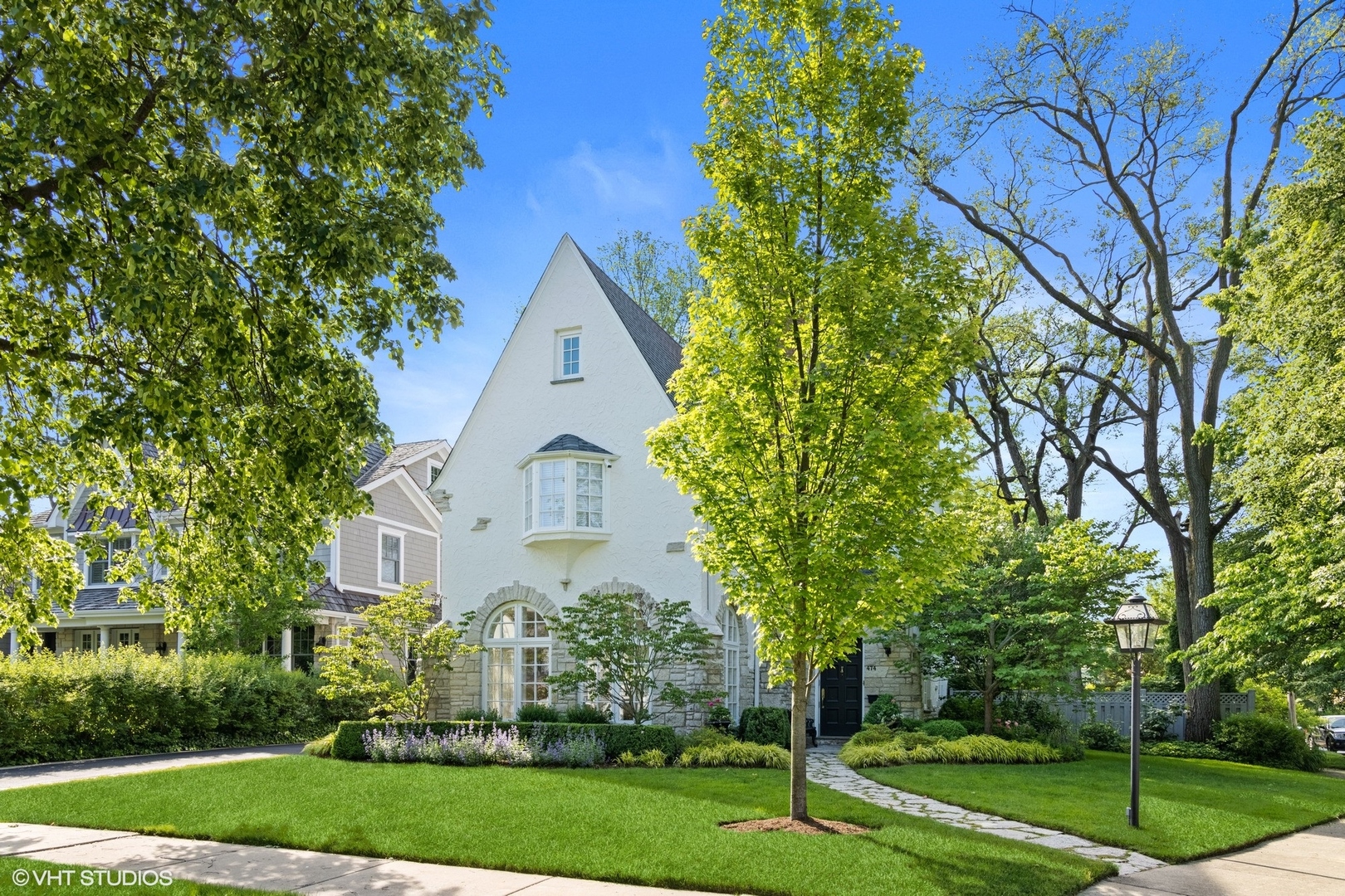 474 Ash Street Winnetka, IL 60093 - Photo 49 of 57 a front view of a house with garden