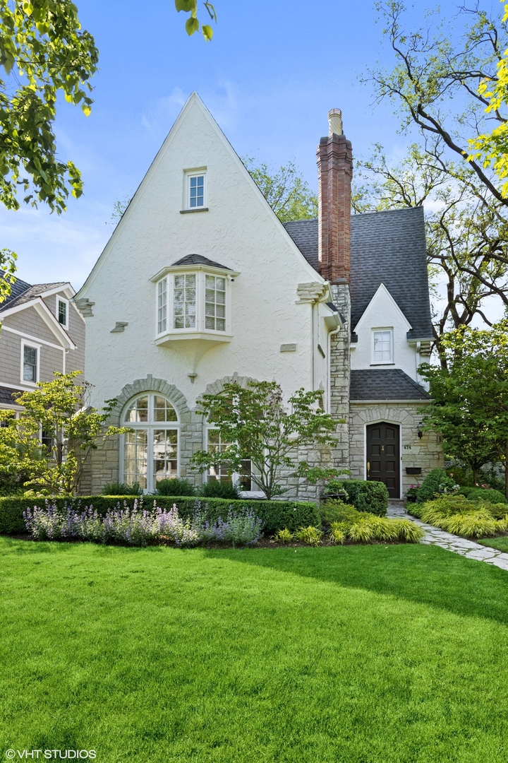 474 Ash Street Winnetka, IL 60093 - Photo 50 of 57 a front view of a house with a garden