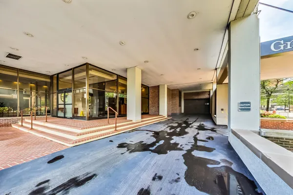 a view of a hall with wooden floor and floor to ceiling window