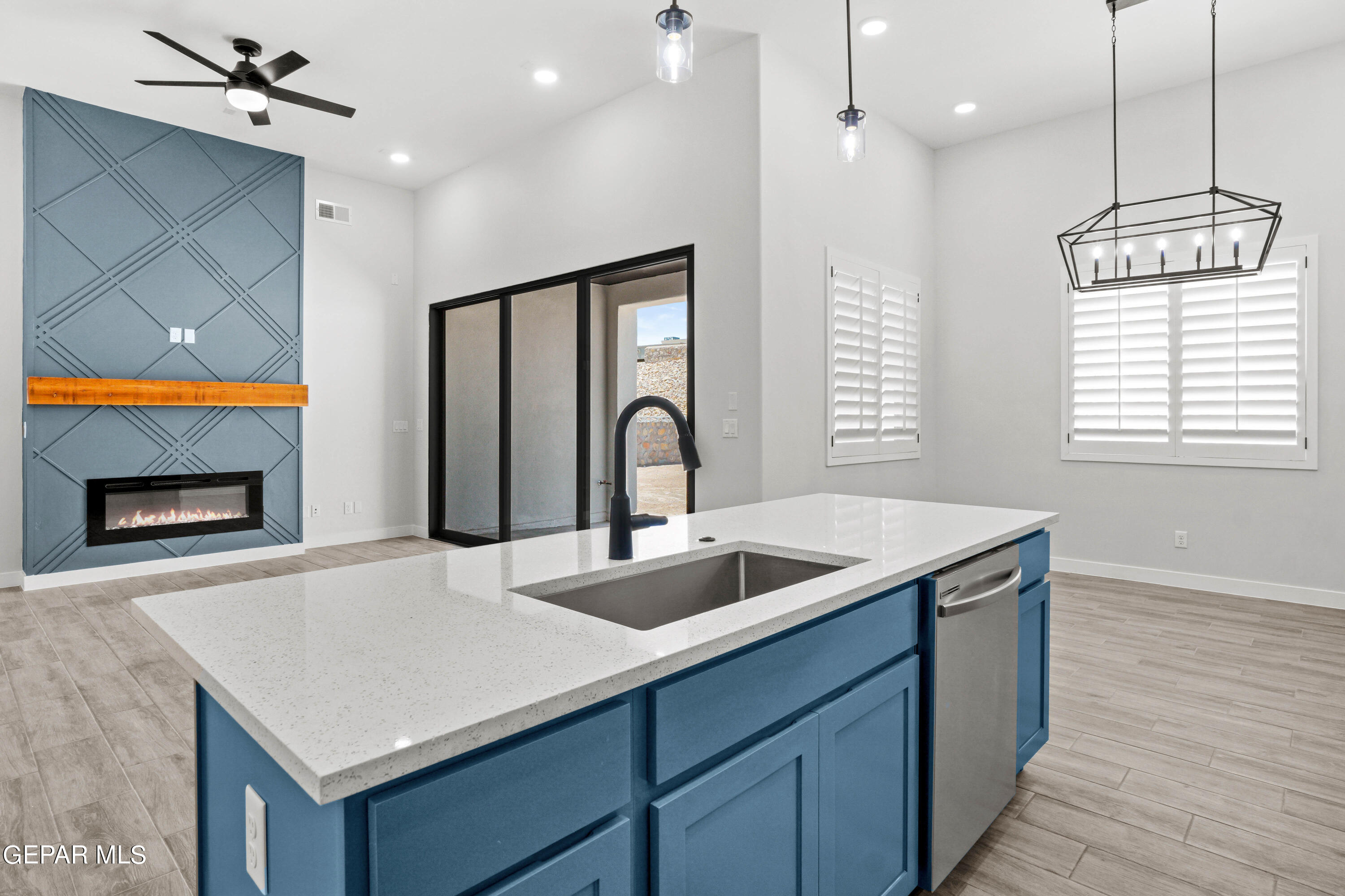 a kitchen that has a sink and a stove top oven