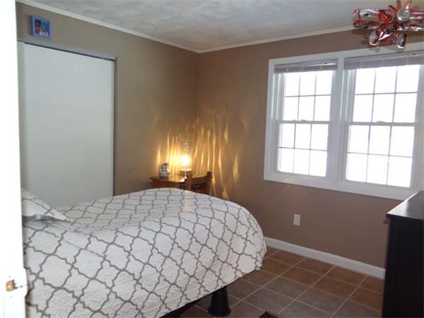 7 Burton Farm Drive Andover, MA 01810 - Photo 14 of 20 a bedroom with a bed and a chandelier