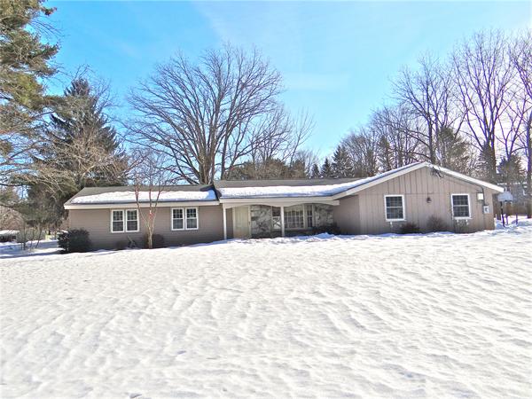 7 Burton Farm Drive Andover, MA 01810 - Photo 20 of 20 a front view of a house with a yard covered in snow