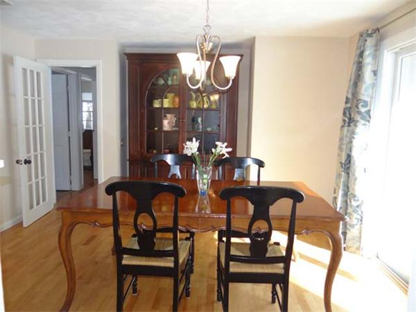 7 Burton Farm Drive Andover, MA 01810 - Photo 4 of 20 a view of a dining room with furniture and chandelier