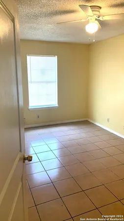 a white toilet sitting next to a bath tub