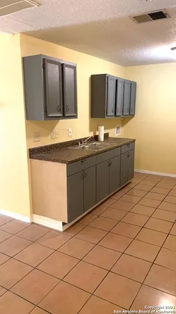 a spacious bathroom with a granite countertop sink and a mirror