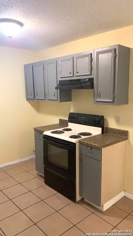 a stove top oven sitting inside of a kitchen