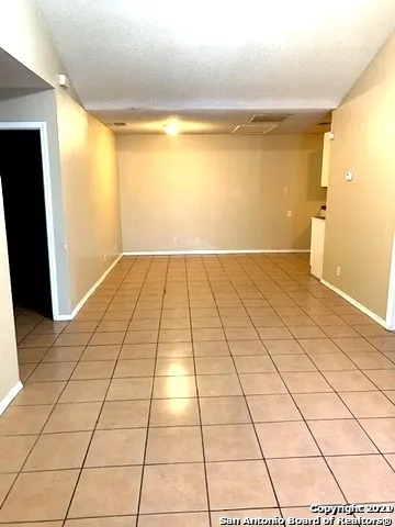 a view of a room with a furniture and a chandelier