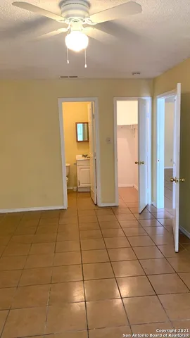 a white toilet sitting next to a bath tub and a shower