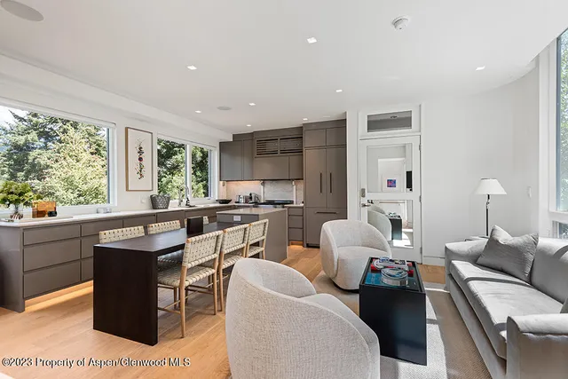 a kitchen with a table chairs sink and cabinets