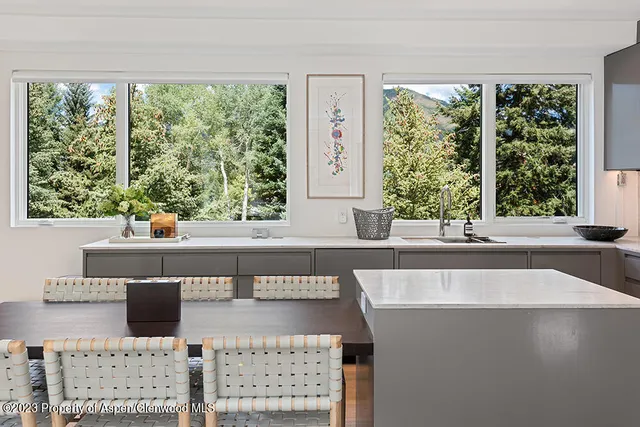 a view of a living room and a floor to ceiling window
