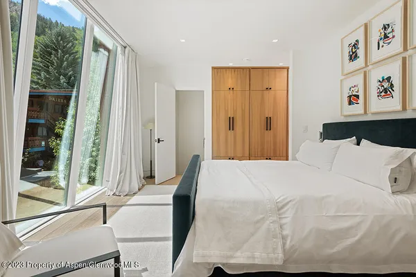 a bedroom with a bed and a large window