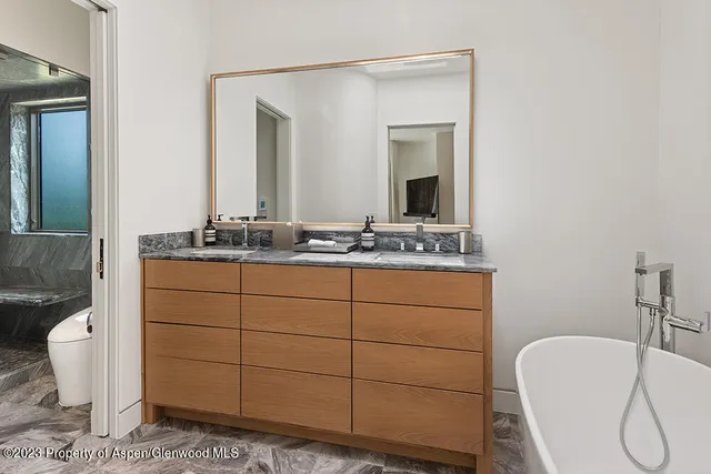 a bathroom with a sink vanity and mirror