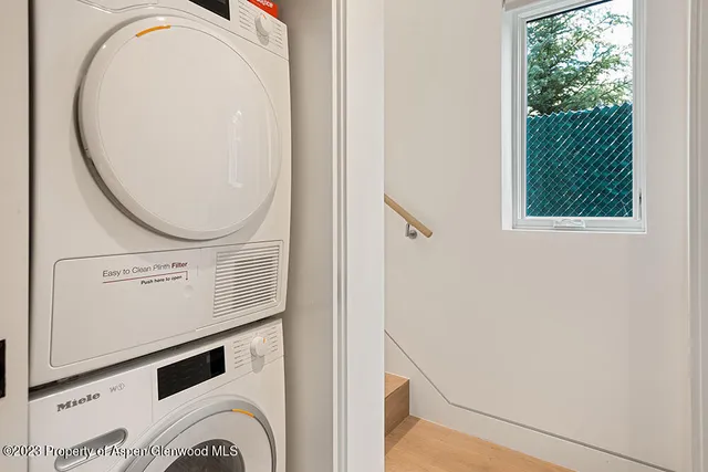 a view of a balcony with a potted plant and stairs