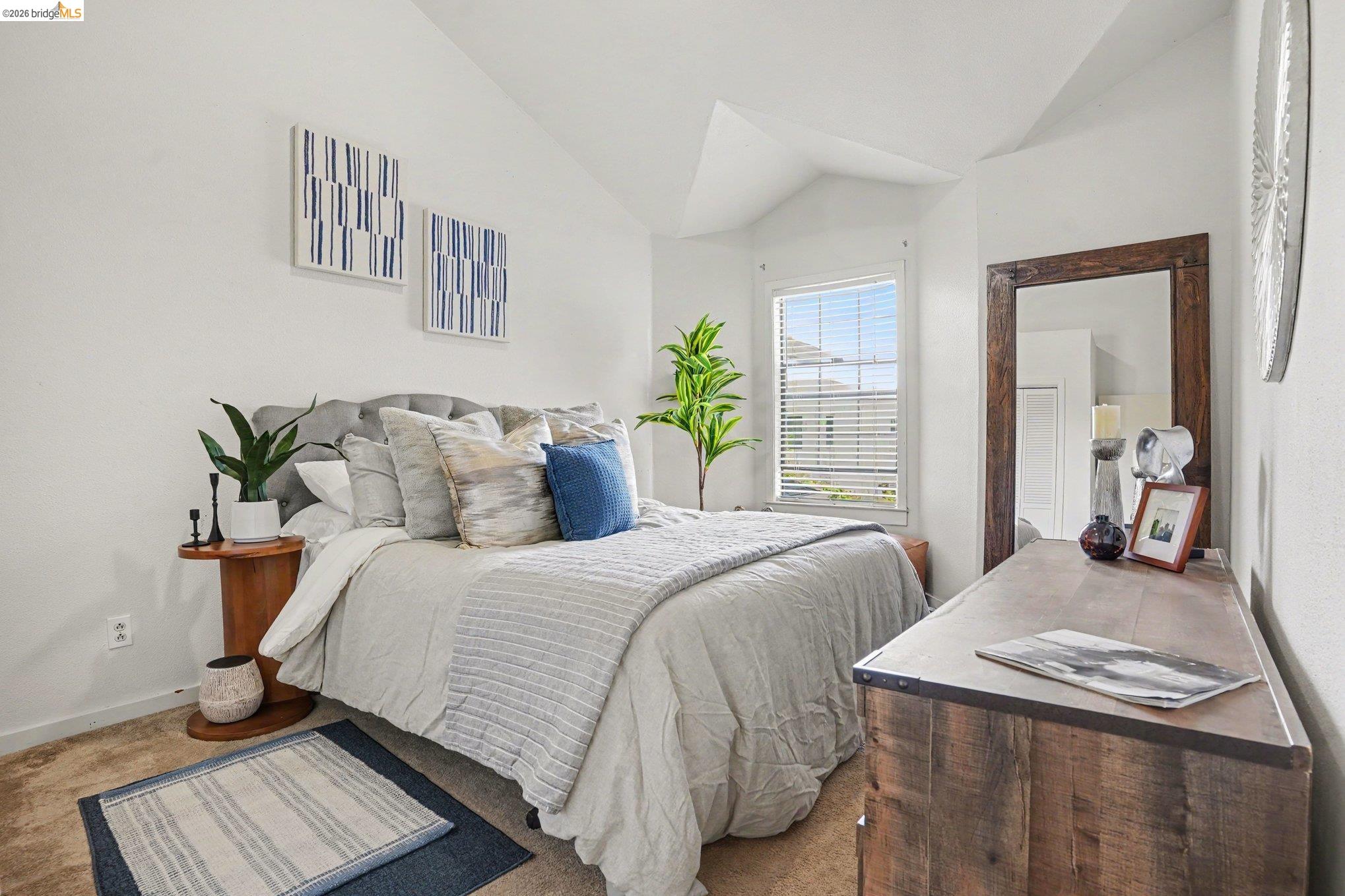 1433 Myrtle Street Oakland, CA 94607 - Photo 17 of 25 Bright bedroom featuring a vaulted ceiling and window with blinds