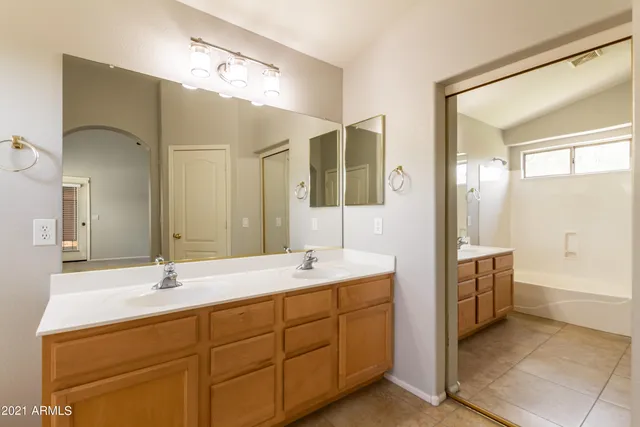 a bathroom with a sink double vanity and a mirror