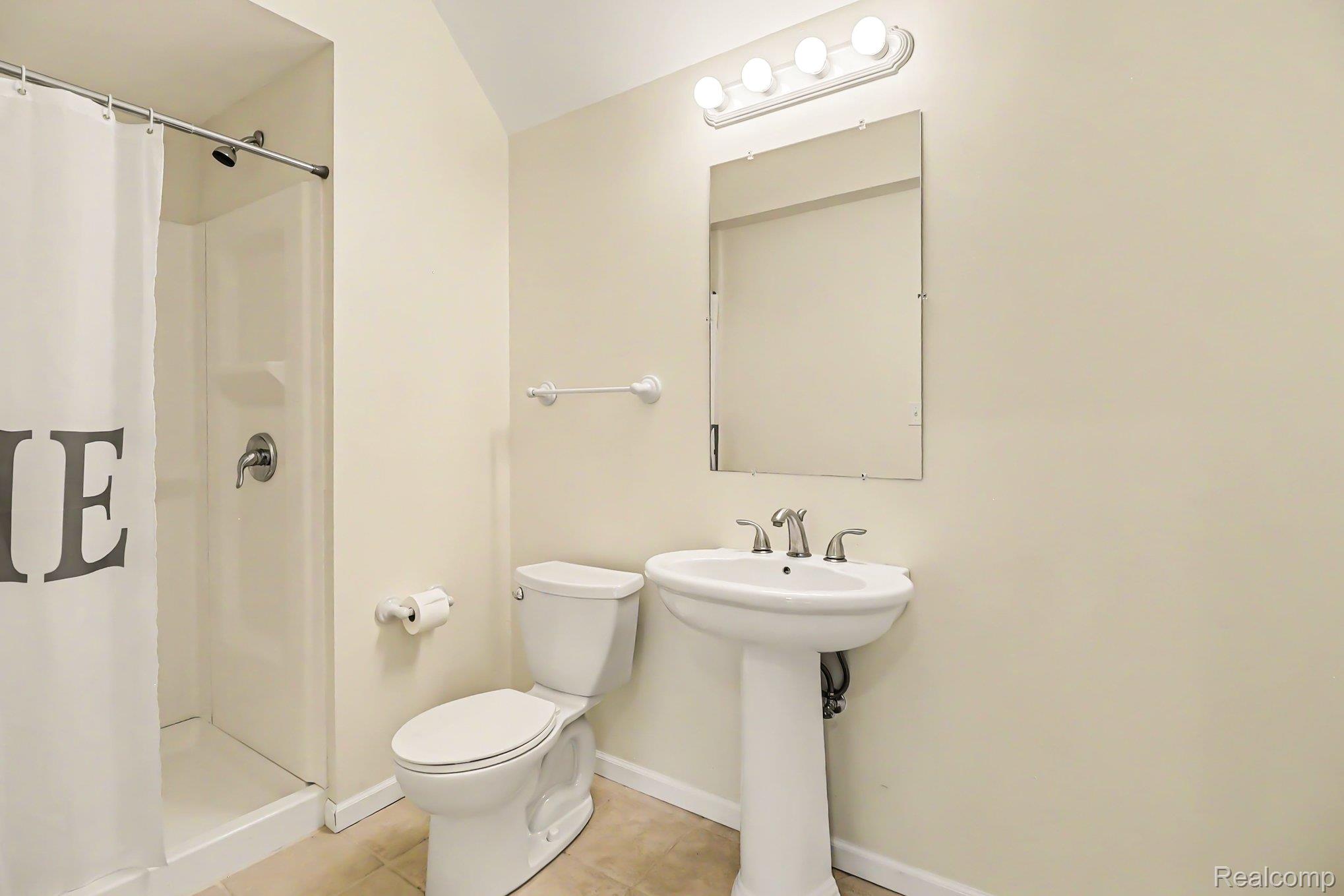 10490 Deer Ridge Trail Holly, MI 48442 - Photo 48 of 56 Full bathroom featuring a white pedestal sink with a chrome faucet, a white toilet, and a white shower/tub combination with a chrome showerhead