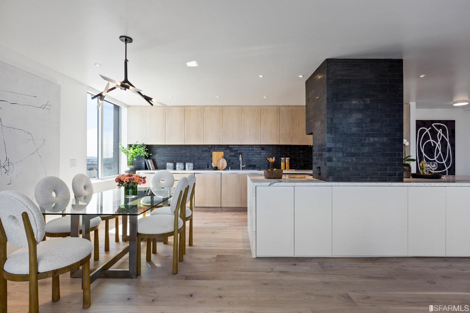 1835 Franklin Street, Unit 1601 San Francisco, CA 94109 - Photo 19 of 37 a living room with furniture a dining table and a chandelier