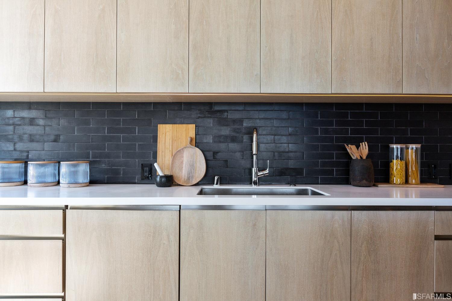 1835 Franklin Street, Unit 1601 San Francisco, CA 94109 - Photo 7 of 37 a kitchen with granite countertop a sink and a stove