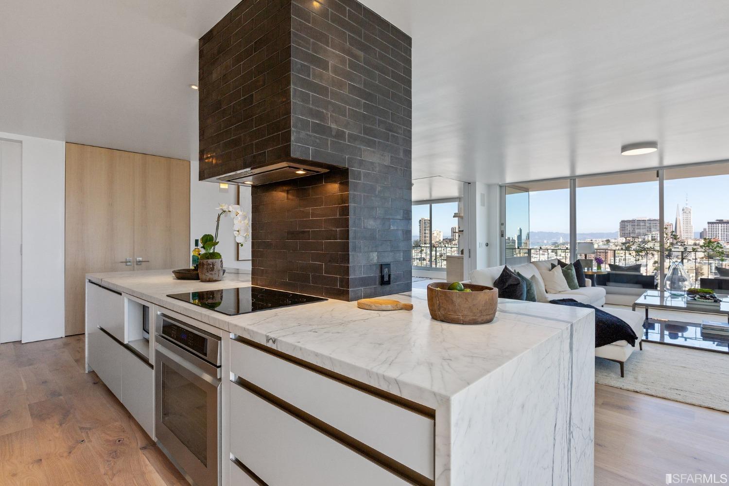 1835 Franklin Street, Unit 1601 San Francisco, CA 94109 - Photo 9 of 37 a kitchen with stainless steel appliances kitchen island granite countertop a sink and cabinets