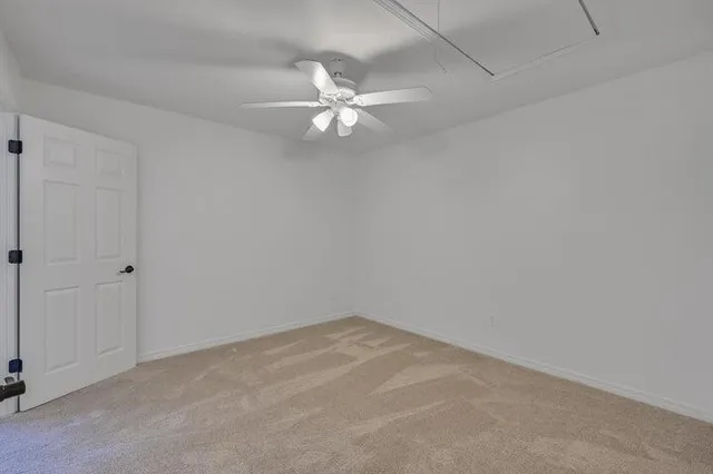 a view of an empty room with a fan