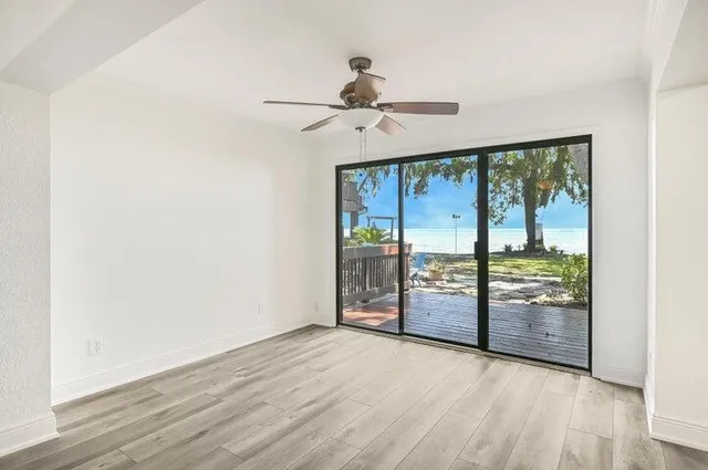 an empty room with sliding door and wooden floor