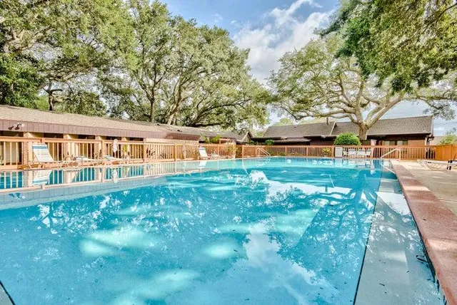 a view of a house with backyard porch and sitting area
