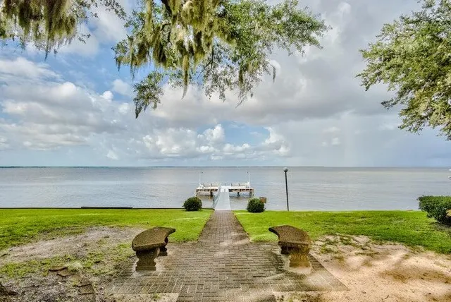 a view of yard with swimming pool and seating