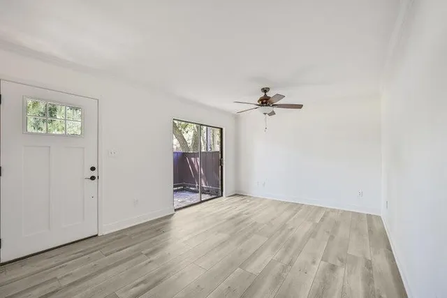 wooden floor in an empty room with a window