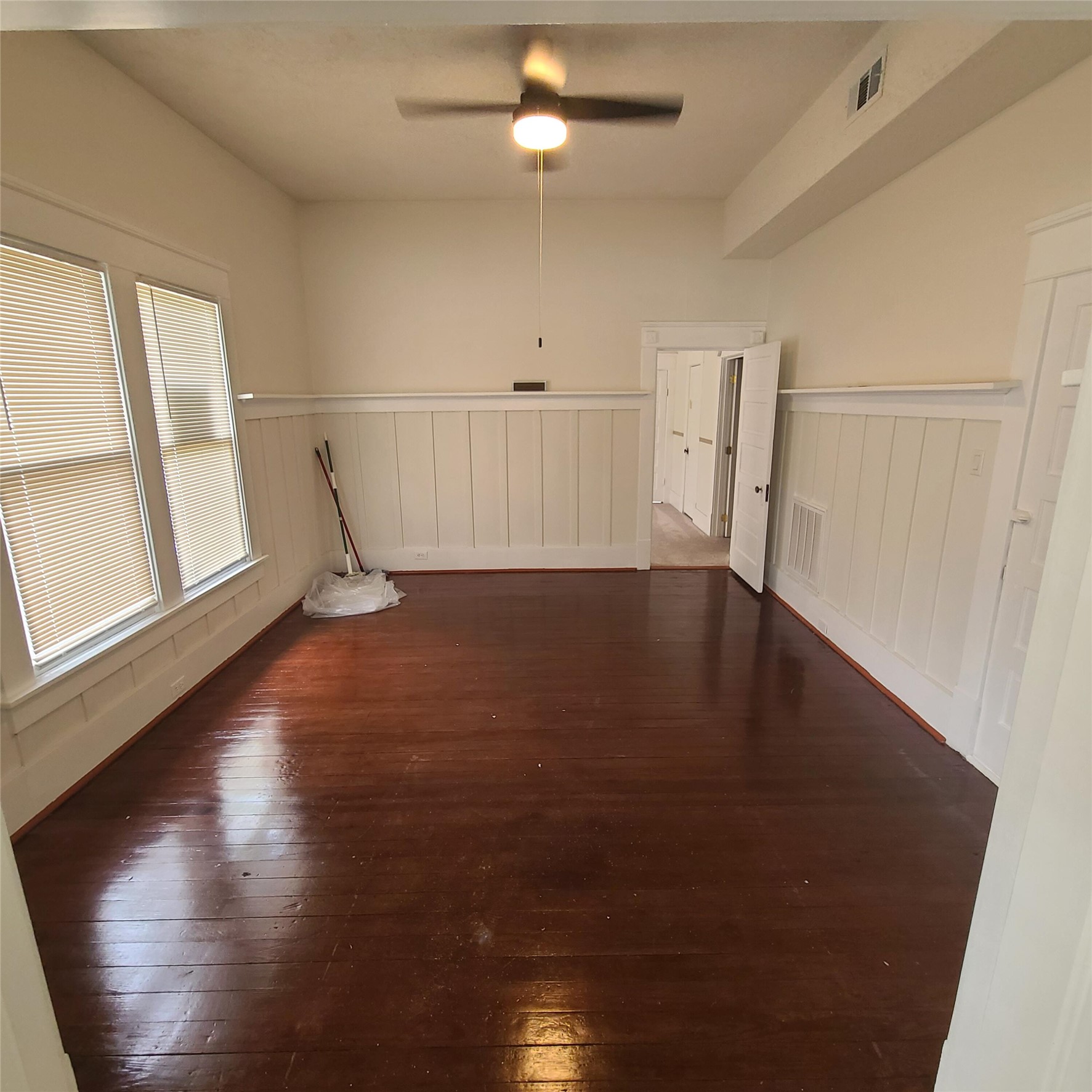 615 East Washington Street Giddings, TX 78942 - Photo 15 of 22 an empty room with wooden floor and windows