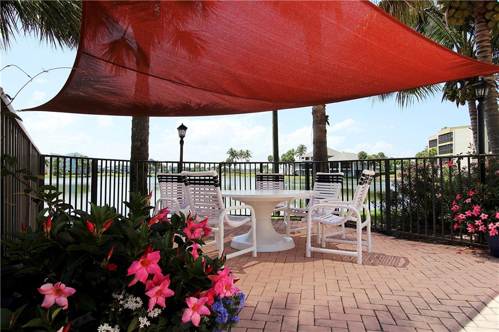 a view of a patio with a table and chairs under an umbrella