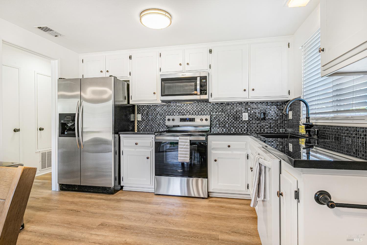 199 White Oak Drive Santa Rosa, CA 95409 - Photo 14 of 37 a kitchen with stainless steel appliances granite countertop a refrigerator sink and stove