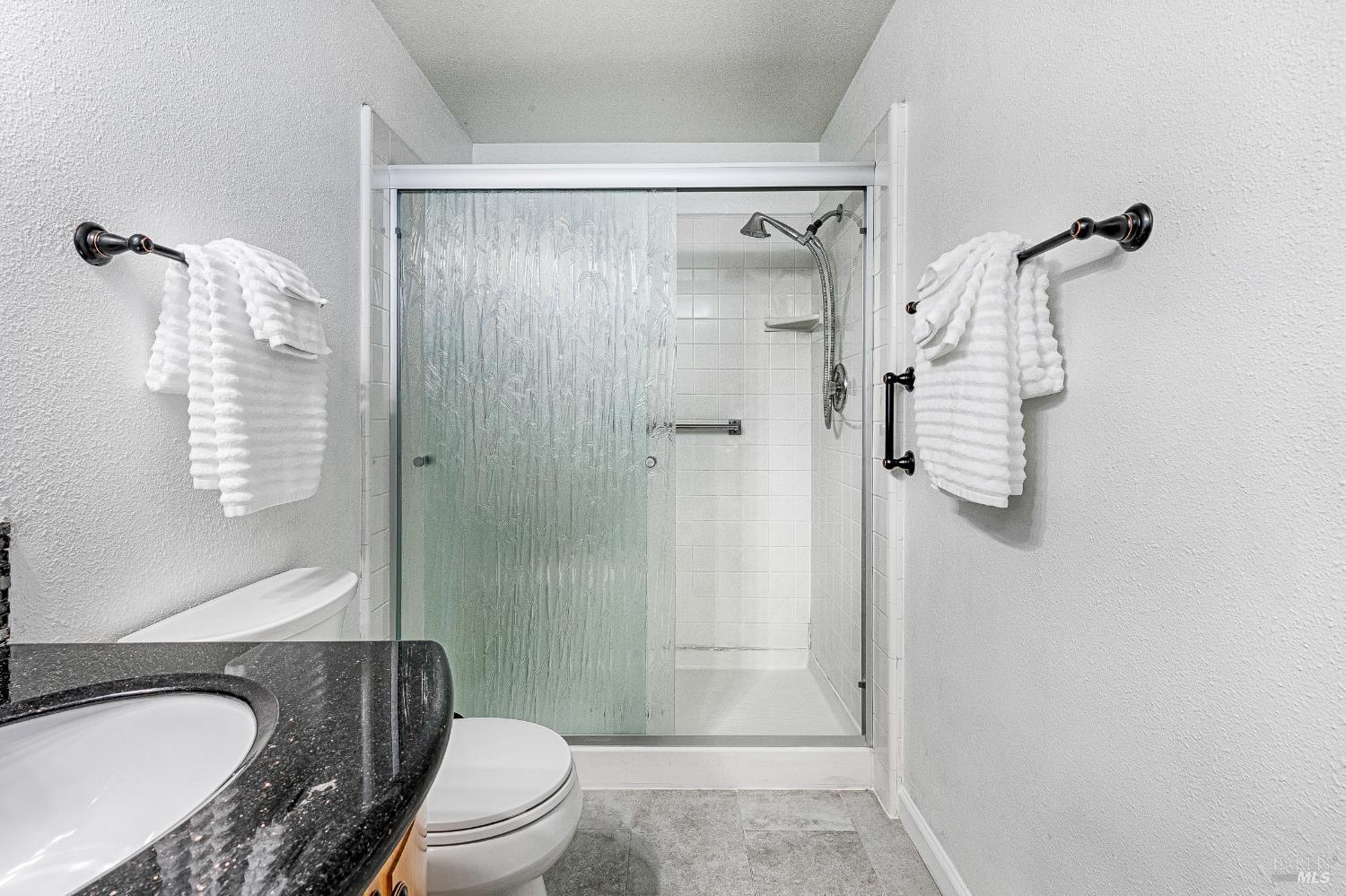 199 White Oak Drive Santa Rosa, CA 95409 - Photo 20 of 37 a bathroom with a granite countertop sink toilet and shower