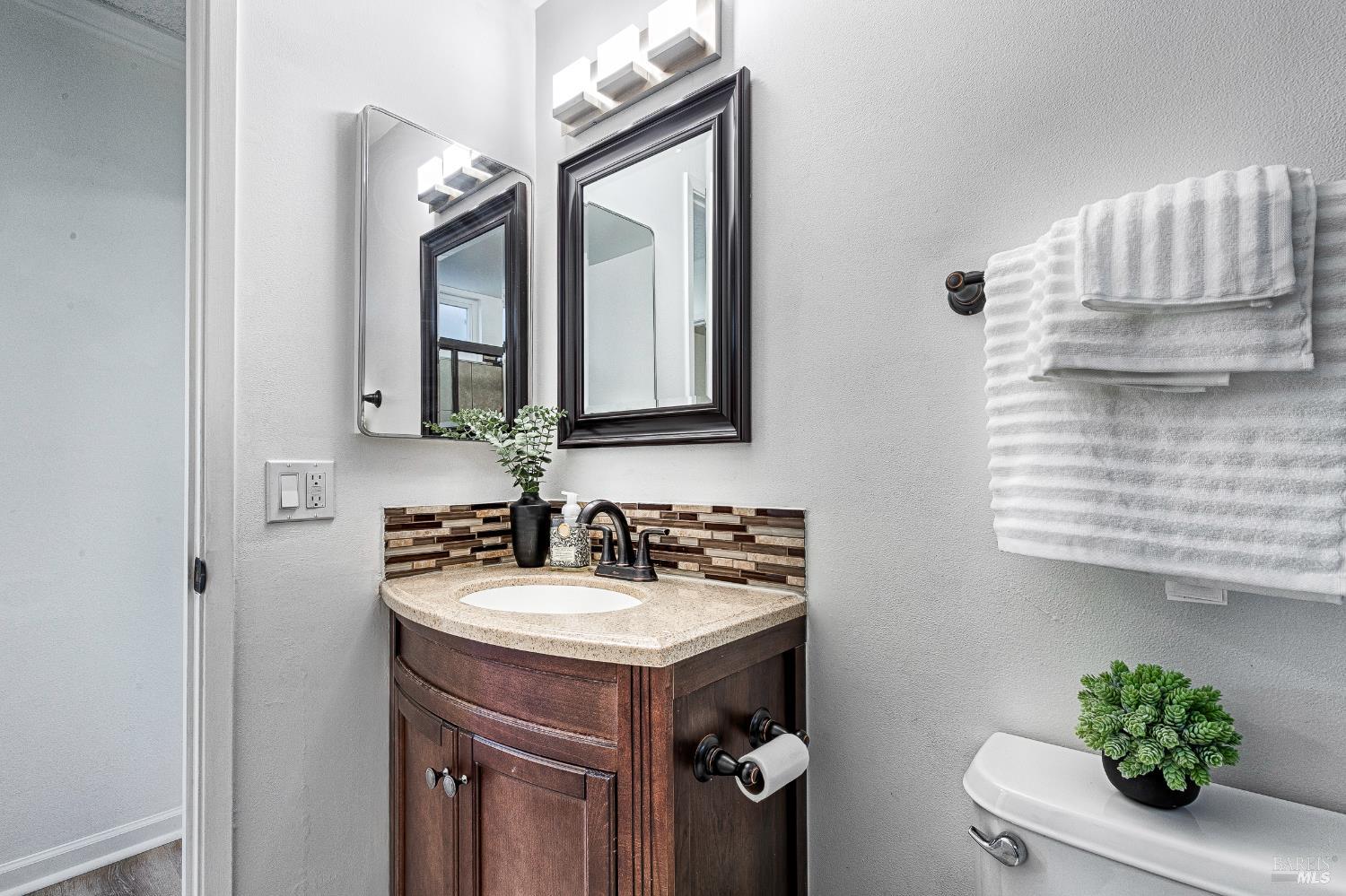 199 White Oak Drive Santa Rosa, CA 95409 - Photo 26 of 37 a bathroom with a sink a mirror and a toilet