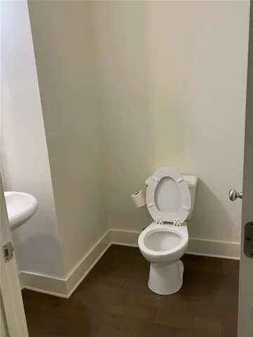 a white toilet sitting in a bathroom