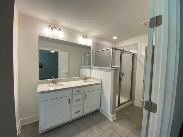 a bathroom with a double vanity sink and mirror
