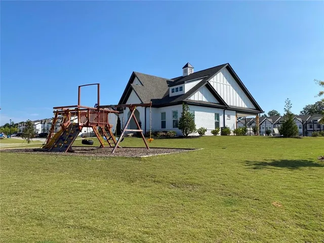 a view of a house next to a lake and mountain
