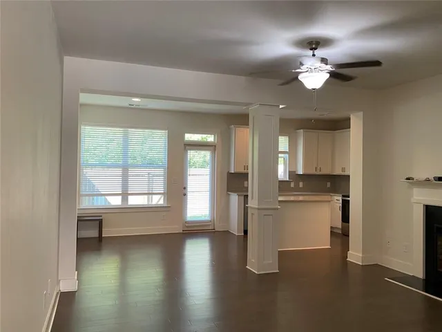 a view of a kitchen with a dishwasher cabinets and a large window