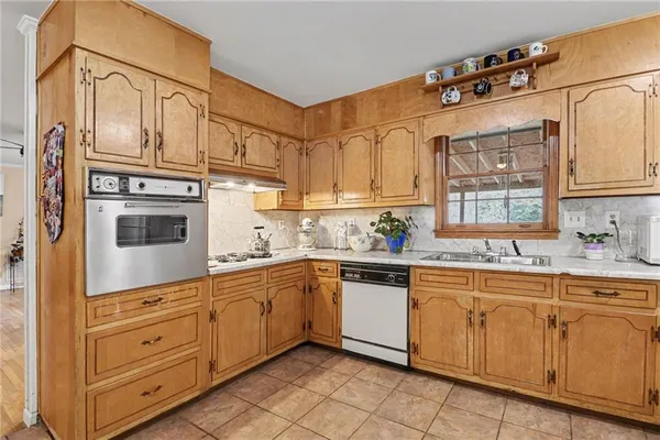 a kitchen with cabinets stainless steel appliances and a sink