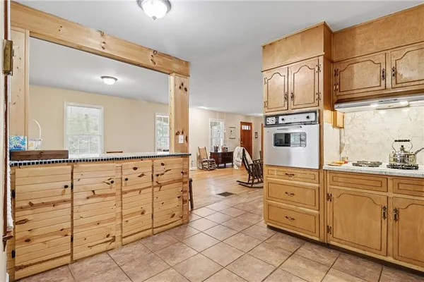 a spacious bathroom with double sink and a mirror a bathtub