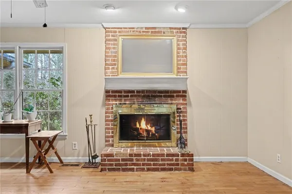 a living room with a fireplace and a window
