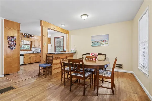 a view of a dining room with furniture and wooden floor