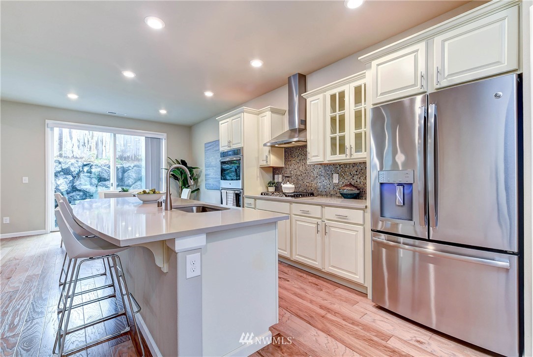 21323 42nd Avenue Southeast Bothell, WA 98021 - Photo 2 of 16 a kitchen with refrigerator a sink and cabinets