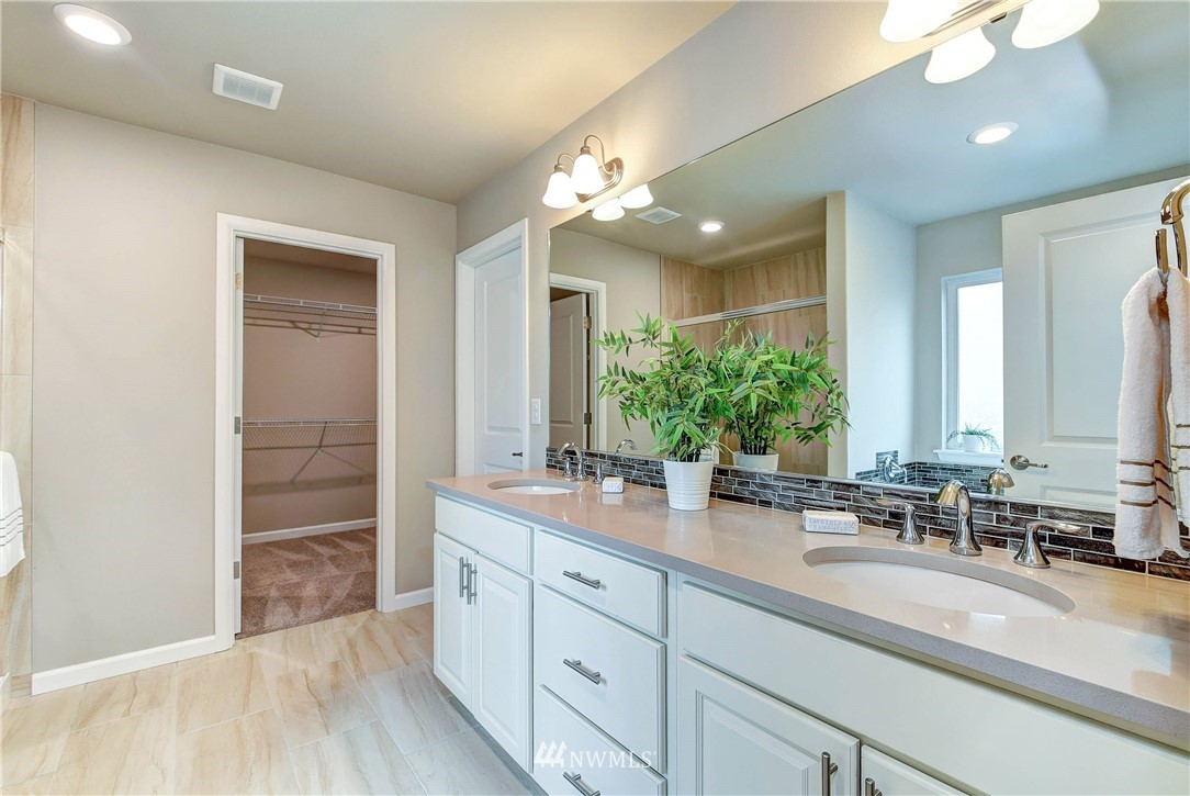 21323 42nd Avenue Southeast Bothell, WA 98021 - Photo 13 of 16 a bathroom with a double vanity sink and a mirror