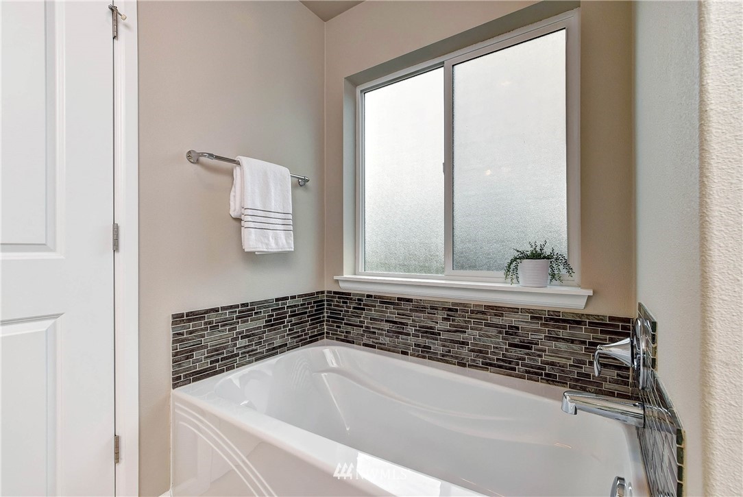 21323 42nd Avenue Southeast Bothell, WA 98021 - Photo 14 of 16 a bathroom with a bathtub and a window