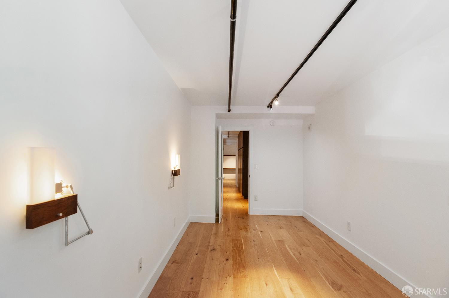 1875 Mission Street, Unit 109 San Francisco, CA 94103 - Photo 14 of 29 a view of empty room with wooden floor