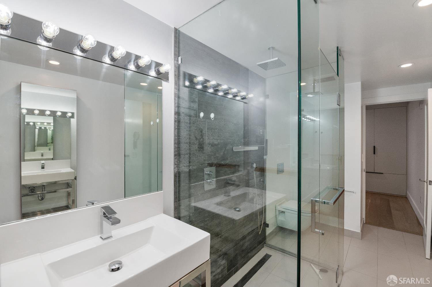 1875 Mission Street, Unit 109 San Francisco, CA 94103 - Photo 15 of 29 a bathroom with a bathtub shower sink and mirror