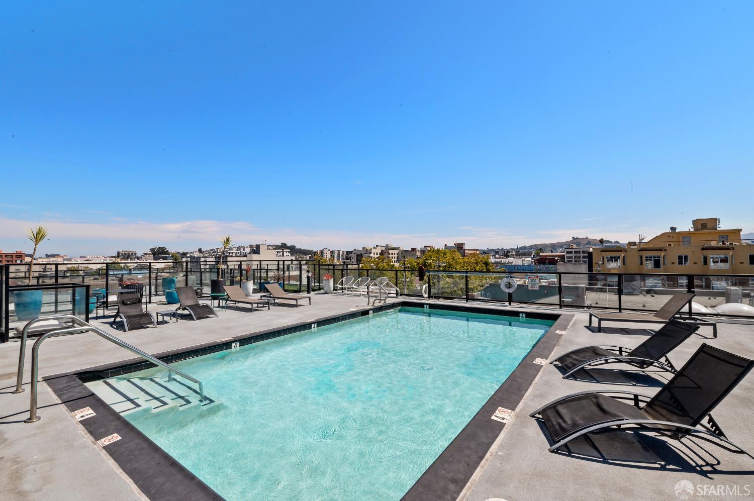 1875 Mission Street, Unit 109 San Francisco, CA 94103 - Photo 26 of 29 a view of a swimming pool and lounge chairs