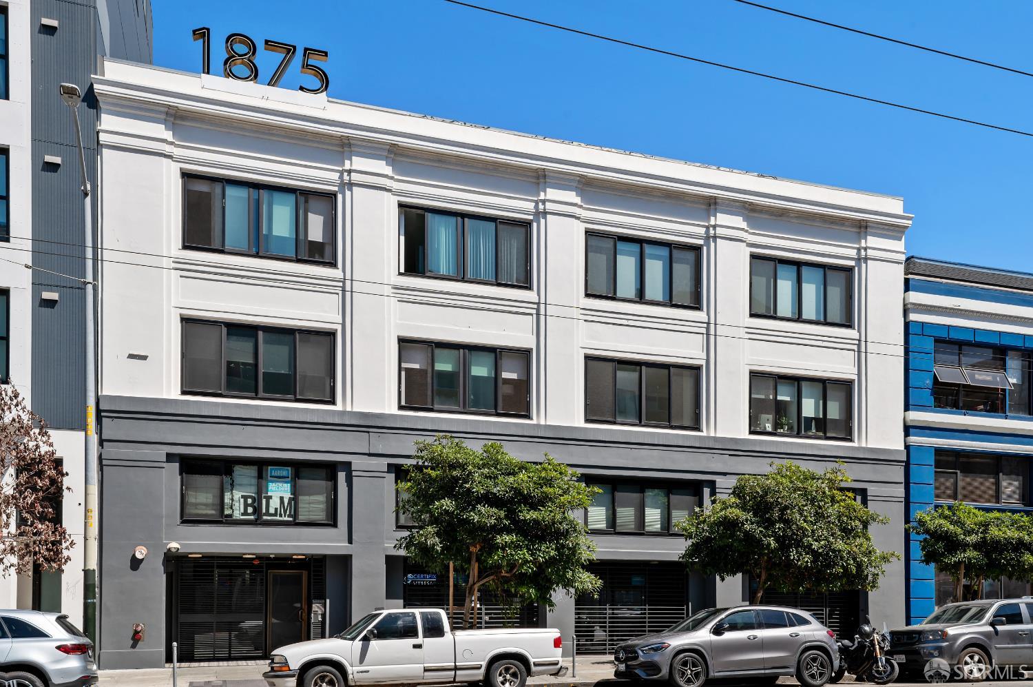 1875 Mission Street, Unit 109 San Francisco, CA 94103 - Photo 29 of 29 a front view of a building with a yard