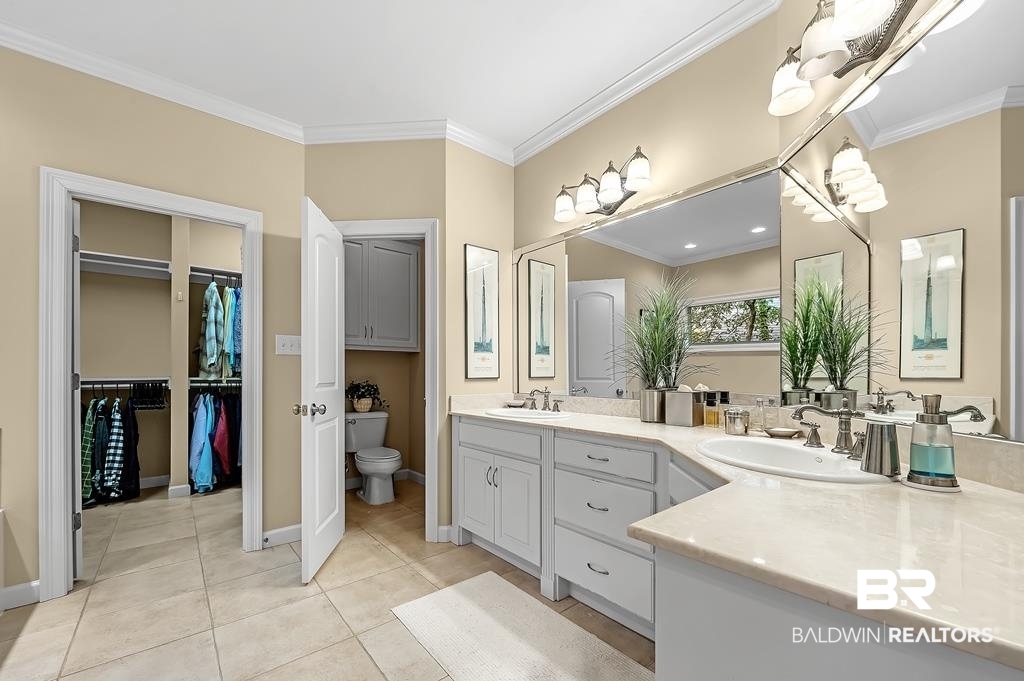 29976 Dolive Ridge Daphne, AL 36527 - Photo 32 of 58 Bathroom with toilet, tile patterned floors, crown molding, and dual bowl vanity