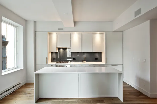 a bathroom with a sink a mirror and a window